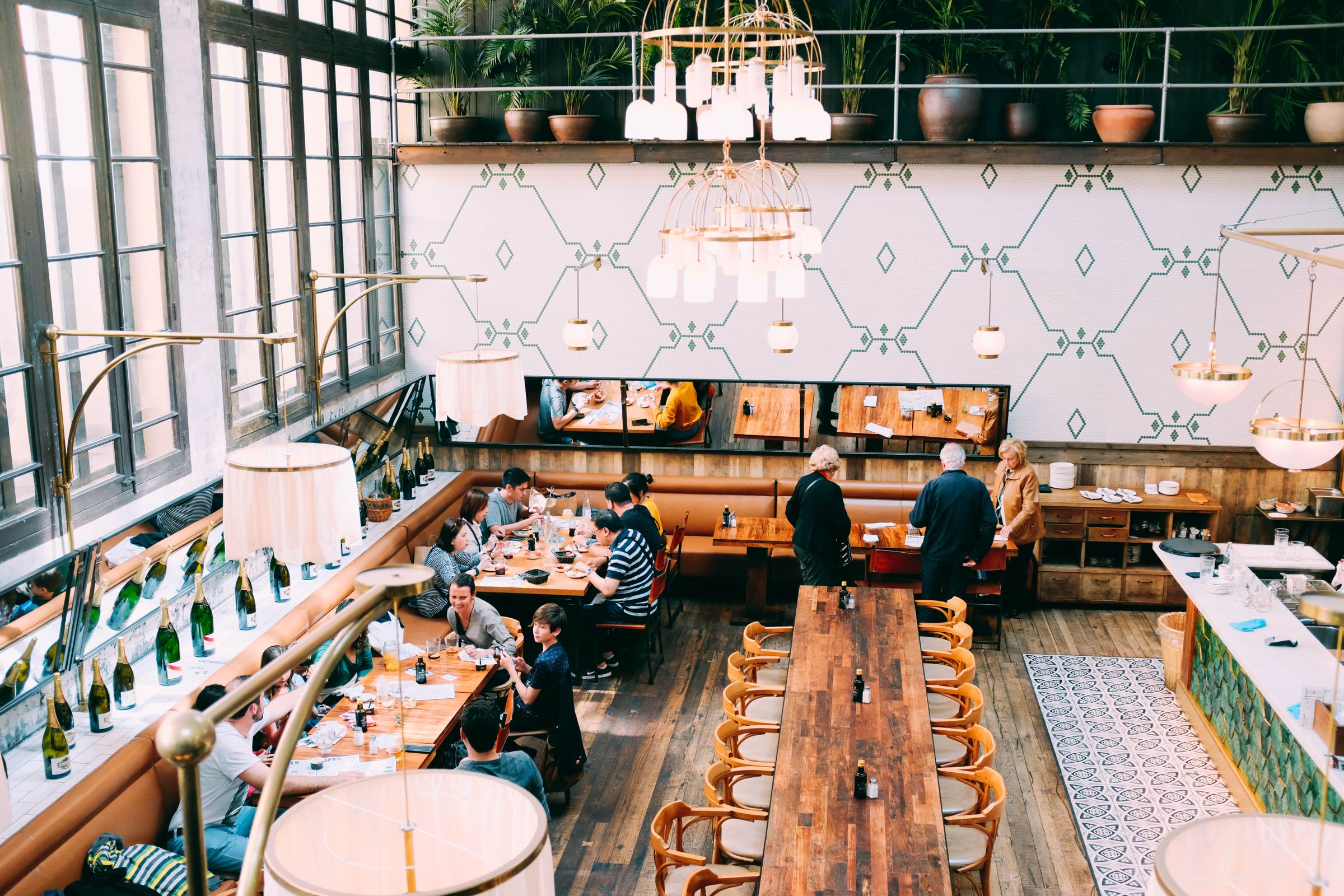 Warmly lit restaurant filled with guests sharing an evening meal